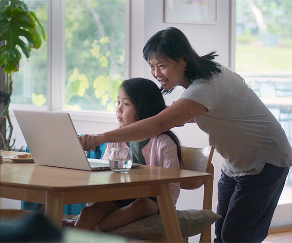 Mum and child looking at laptop